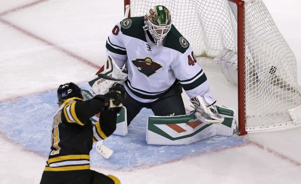 Boston Bruins left wing Loui Eriksson shoots his third goal of the game past Minnesota Wild goalie Devan Dubnyk (40). It was Eriksson's third career hat trick. (Charles Krupa/AP)