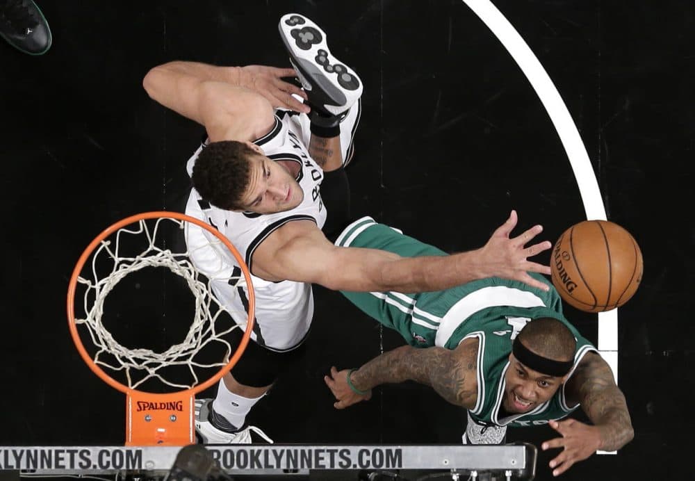 Boston Celtics guard Isaiah Thomas, right, shoots against Brooklyn Nets center Brook Lopez (11) during the game in New York. The Nets won 111-101. (Julie Jacobson/AP)