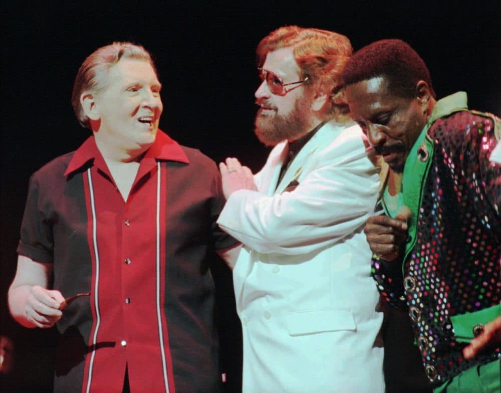 Rock 'n' roll recording pioneer Sam Phillips, center, chats with Jerry Lee Lewis, left, and Ike Turner at a party debuting Phillips' documentary in 2000. (AP/John L. Focht)