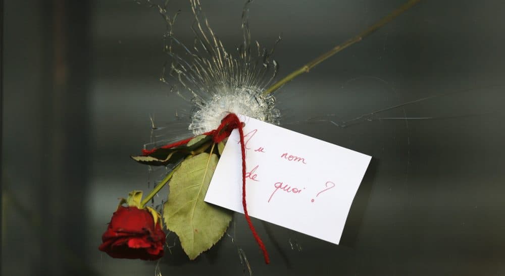 John Tirman: "France was the epicenter of the Enlightenment that fairly defines Western civilization. And the jihadis, in their reckless, apocalyptic pathology, detest above all such values." Pictured: A message that reads: 'In the name of what?' and a rose is placed through a bullet hole in a window at the restaurant on Rue de Charonne, Paris, Sunday, Nov. 15, 2015, where attacks took place on Friday. (Frank Augstein/AP)