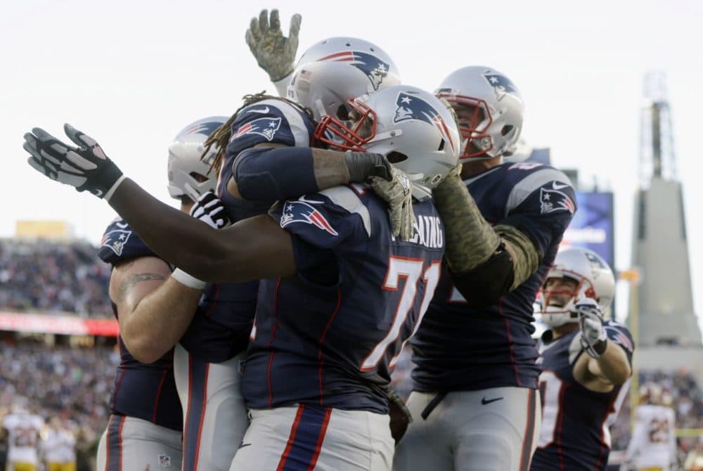 New England Patriots running back Brandon Bolden celebrates with guard Cameron Fleming (71) after scoring a touchdown in against the Washington Redskins during the second half. (Steven Senne/AP)