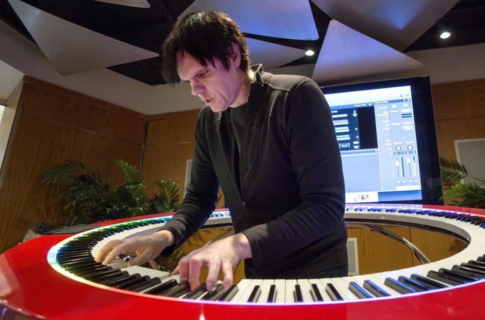 Keyboard player Brockett Parsons plays a 360-degree keyboard at the Berklee College of Music. Parsons is part of Boston startup PianoArc, which produced the circular keyboard and hopes it will make a mark in the music industry. (Robin Lubbock/WBUR)