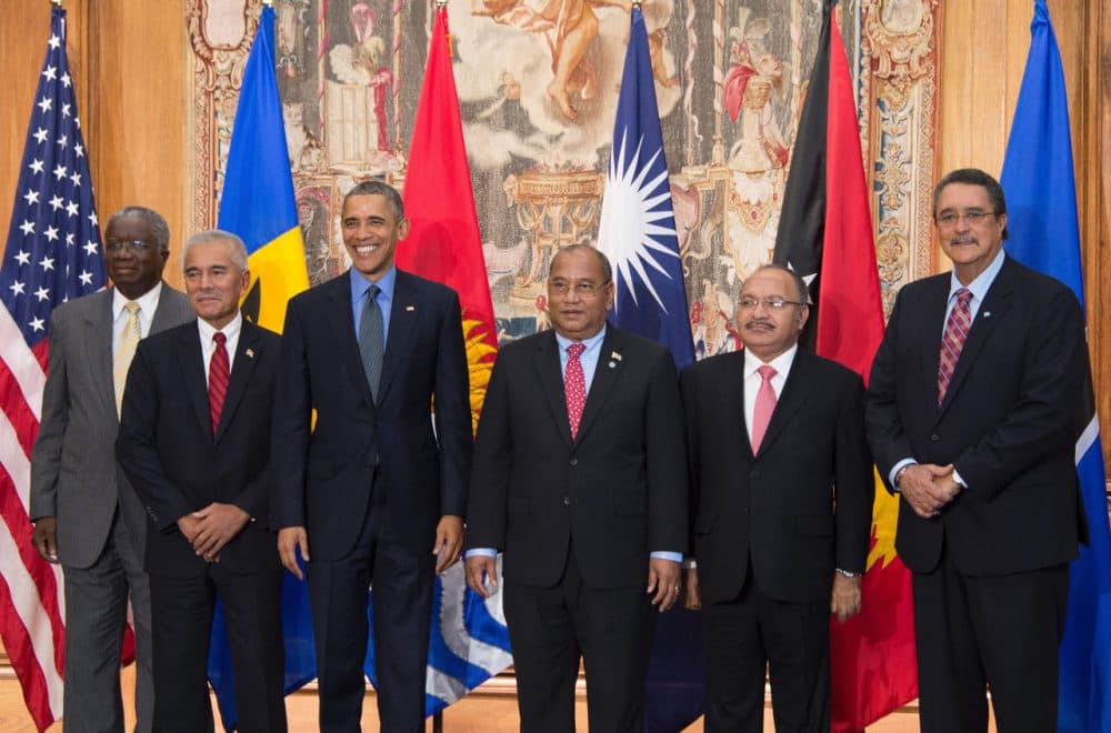 US President Barack Obama (3rd L) poses with Barbados Prime Minister Freundel Stuart (L), Kiribati President Anote Tong (2nd L), Mashall Islands President Christopher Loeak (3rd R), Papua New Guinea Prime Minister Peter O'Neil (2nd R) and St. Lucia Prime Minister Kenny Anthony (R) during a photo for the small island nations multilateral meeting at the Organization for Economic Co-Operation and Development Centre in Paris, on December 1, 2015. (Jim Watson/AFP/Getty Images)