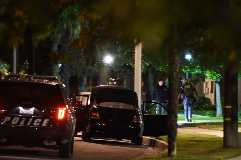 FBI agents work in the early morning hours of December 3, 2015 searching a Redlands, California neighborhood where a home linked to suspects in the San Bernardino shooting rampage is located. A heavily armed man and woman killed at least 14 people and injured at least 17 at a social services center in nearby San Bernardino on December 2, 2015 before the suspects died during a shootout with police. (Robyn Beck/AFP/Getty Images)