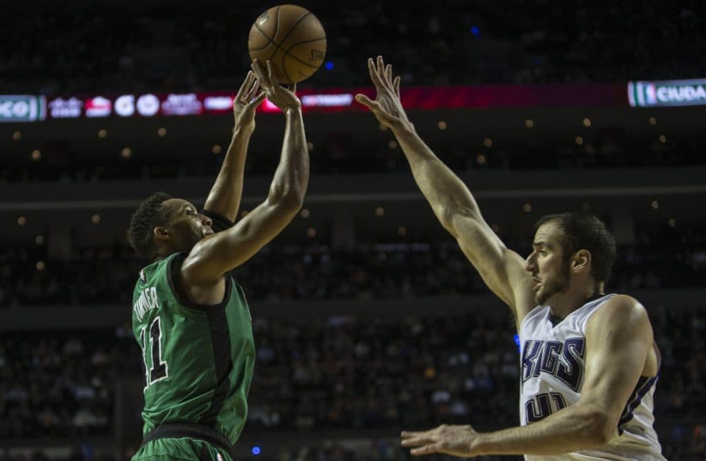 Boston Celtics' Evan Turner, left, gets to ready to try a shot under pressure of Sacramento Kings' Kosta Koufos during a game Thursday night. (Christian Palma/AP)