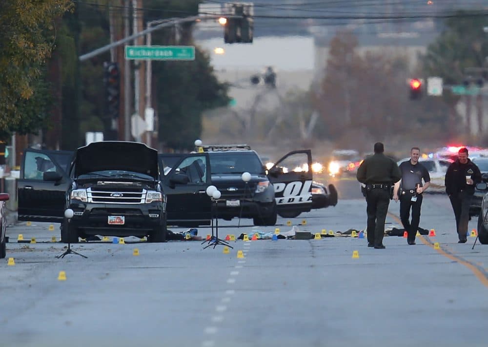 Law enforcement officials continue their investigation around the Ford SUV vehicle that was the scene where suspects of the shooting at the Inland Regional Center were killed on December 4, 2015 in San Bernardino, California. Police continue to investigate a mass shooting at the Inland Regional Center in San Bernardino that left at least 14 people dead and another 17 injured on December 2nd. (Joe Raedle/Getty Images)