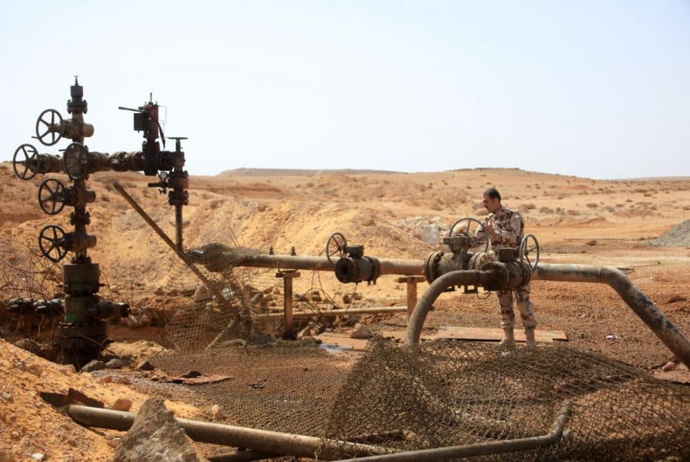 A member of the Syrian government forces stands next to a well at Jazel oil field, near the ancient city of Palmyra in the east of Homs province after they retook the area from Islamic State group fighters on March 9, 2015. Recent U.S.-led coalition airstrikes have frequently targeted oil facilities run by ISIS jihadists, who according to some estimates earn more than $1 million per day from oil sales. (STR/AFP/Getty Images)