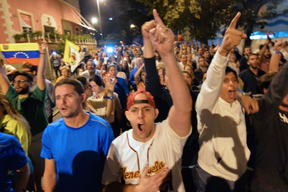 Venezuelan opposition supporters celebrate the results of the legislative election in Caracas, on the early morning December 7, 2015. Venezuela's opposition won --at least - a majority of 99 out of 167 seats in the state legislature, electoral authorities said Monday, the first such shift in power in congress in 16 years. (Luis Robayo/AFP/Getty Images)