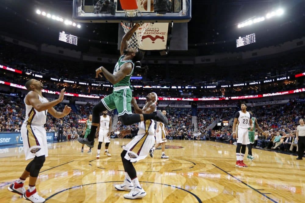 Boston Celtics forward Jae Crowder (99) drives to the basket in front of New Orleans Pelicans guard Eric Gordon, left, and forward Dante Cunningham during last night's game in New Orleans. (Gerald Herbert/AP)