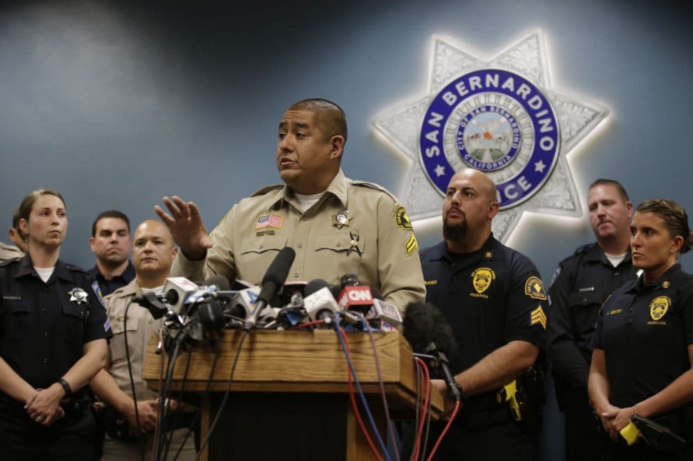 San Bernardino County Sheriff's detective Jorge Lozano, center, answers questions from reporters during a news conference with the first responders on the scene of last week's shooting, Tuesday, Dec. 8, 2015, in San Bernardino, Calif. Lozano was captured on video in a hallway of the Inland Regional Center telling employees and others who were stranded to follow him and that he would "take a bullet before you do." (Jae C. Hong/AP)