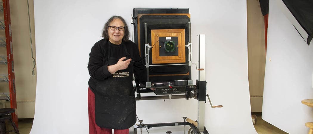 A fixture in Cambridge for decades and known for portraits often described as capturing the soul of her subjects, Esla Dorfman is taking her last shots. Here, Dorfman stands with her huge 20x24 Polaroid camera in her Cambridge studio. (Jesse Costa/WBUR)