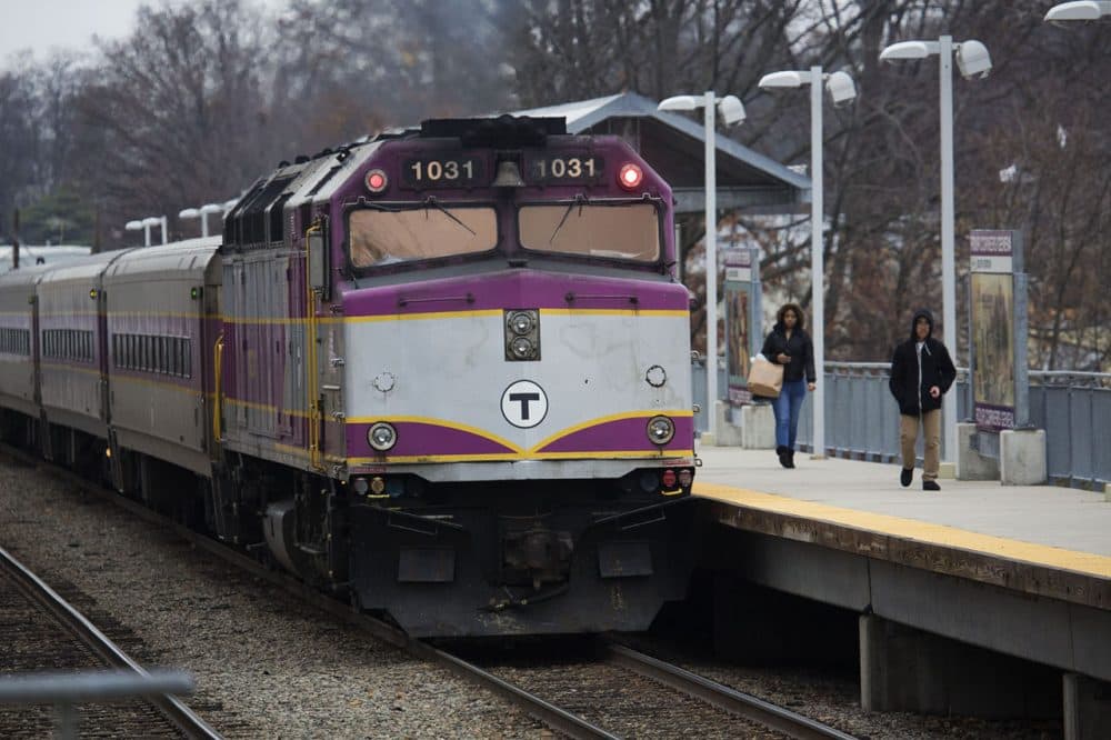 Passangers walk on the platform after disembarking an MBTA Commuter Rail train as it leaves the Four Corners/Geneva Station on the Fairmount Line. (Jesse Costa/WBUR)