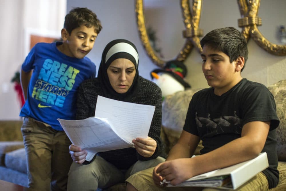 Six days after the San Bernardino shooting, 14-year-old Hassan Messelmani (R) was told by a teacher to "quit acting like a terrorist." He's shown here with his mother Samira Elzayat and 6-year-old brother Rami. (Maya Sugarman/KPCC)