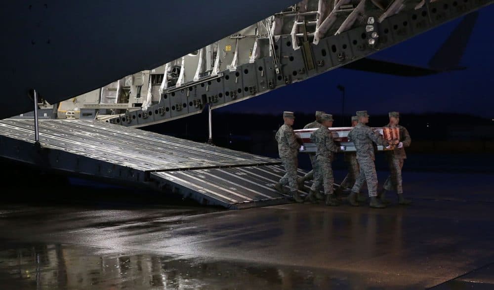 A U.S. Air Force carry team moves the transfer case of U.S. Air Force Staff Sgt. Chester J. McBride during a dignified transfer at the New Castle Air National Guard Base on December 23 in New Castle, Delaware. Staff Sgt. McBride was killed when a suicide bomber rammed an explosive-laden motorcycle into a joint patrol with Afghan security forces outside of Bagram Air Base in Afghanistan. (Mark Wilson/Getty Images)