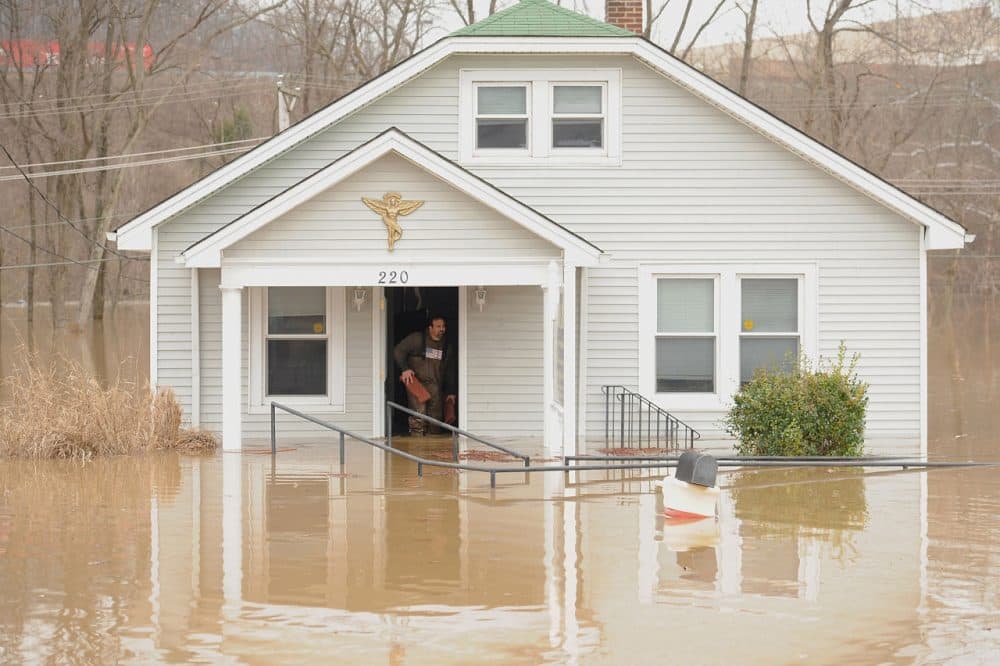 A man removes debris from a business on December 30 in Fenton, Missouri. The St. Louis area and surrounding region experiencing record flood crests of the Mississippi, Missouri and Meramac Rivers after days of record rainfall. (Michael B. Thomas/Getty Images)