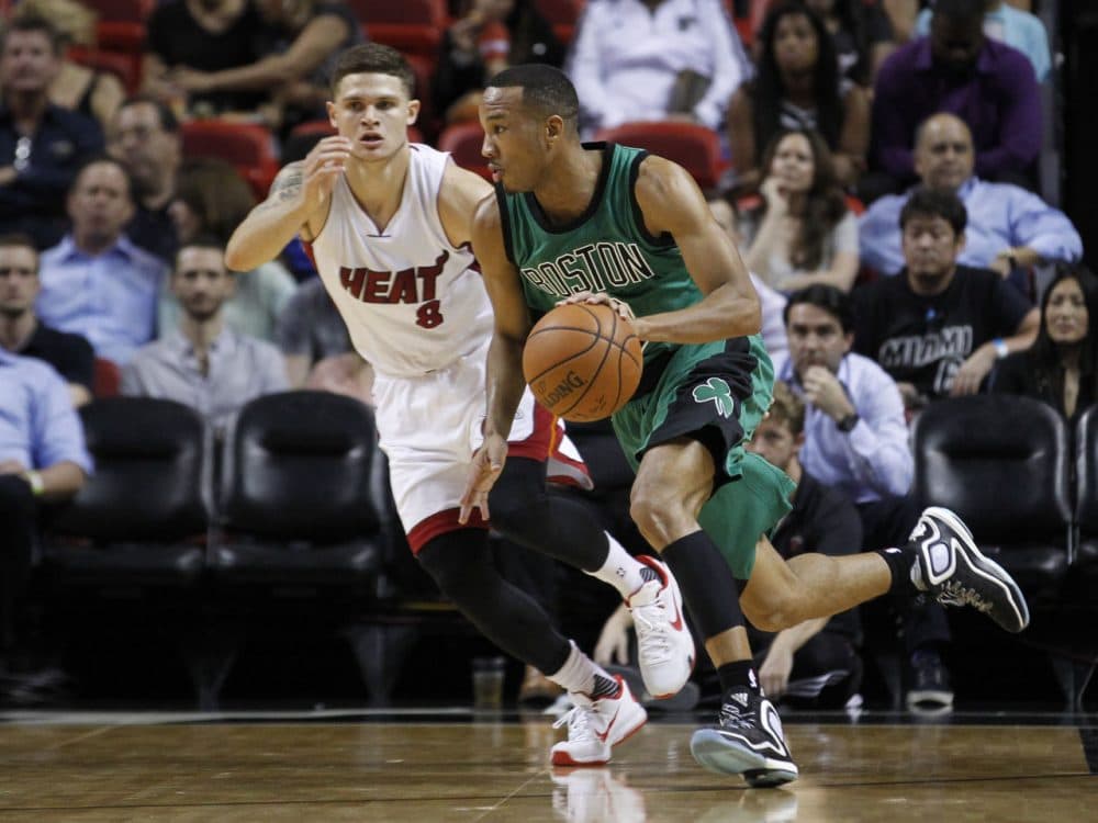 Boston Celtics guard Avery Bradley drives past Miami Heat guard Tyler Johnson in the first half of last night's game in Miami. The Celtics won the game 105-95. (Joe Skipper/AP)