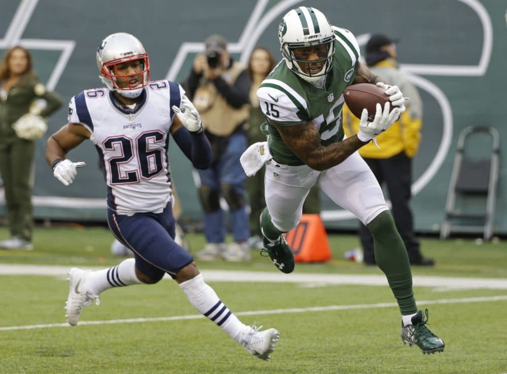 New York Jets wide receiver Brandon Marshall (15) catches a pass for a touchdown in front of New England Patriots' Logan Ryan (26) during a game, Sunday, Dec. 27, 2015. (Seth Wenig/AP)