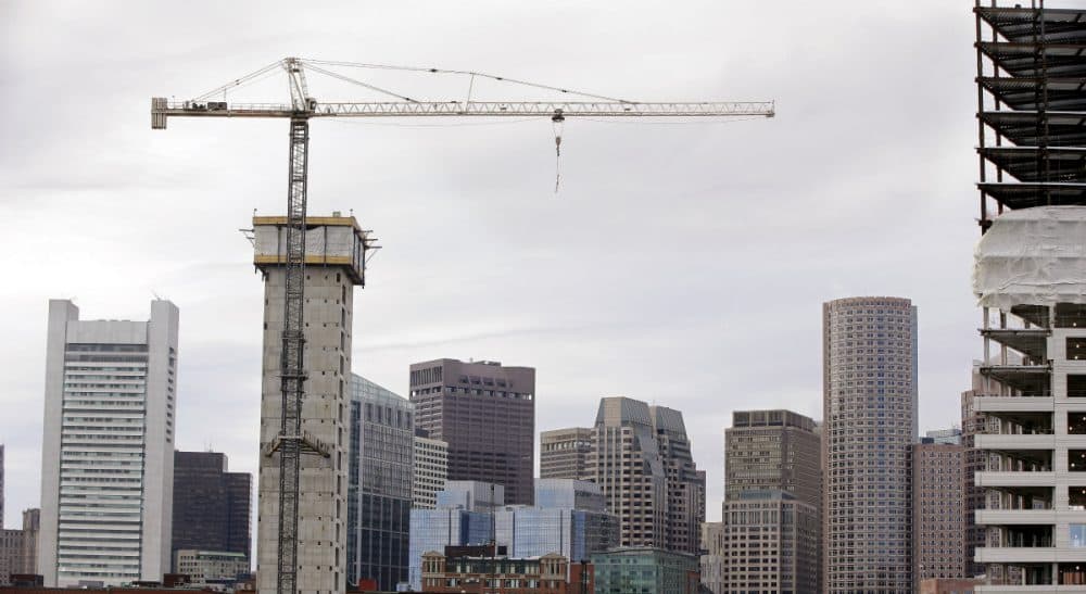 Mike Broida: "A city is only as vibrant as its population is diverse."
Pictured: Several commercial construction projects in the Seaport district of Boston as seen against the backdrop of the city's skyline. (Stephan Savoia/AP)