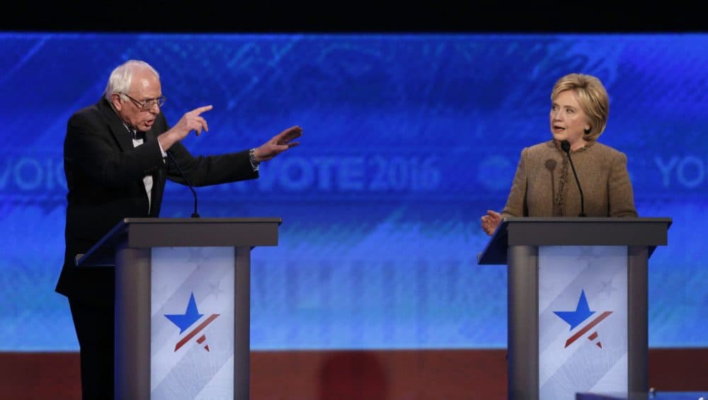 Bernie Sanders and Hillary Clinton speak during the Democratic presidential primary debate Saturday at Saint Anselm College in Manchester, N.H. (Jim Cole/AP)
