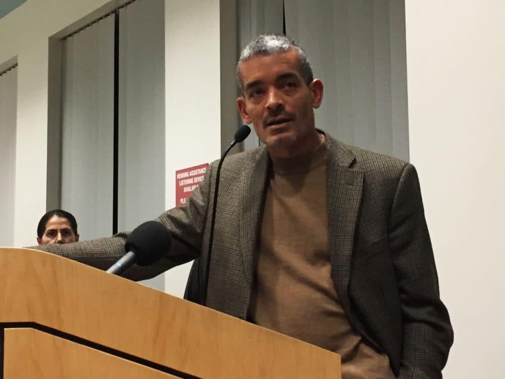 Brookline Officer Prentice Pilot, speaking at Tuesday night's meeting, claims a commanding officer directed a racial epithet toward him. (Simon Rios/WBUR)