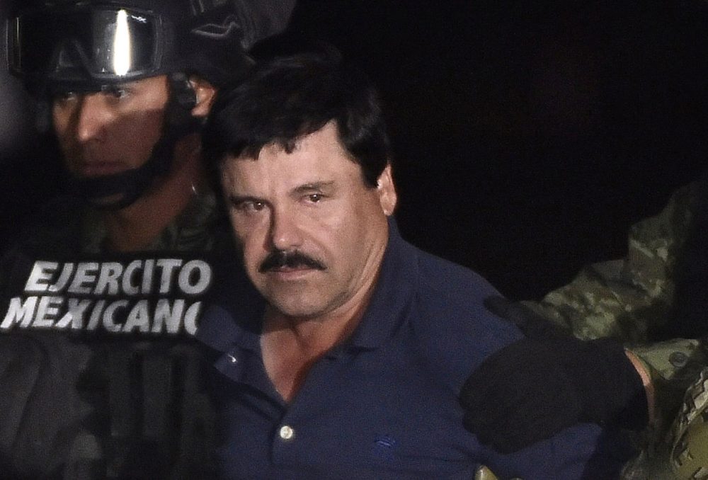 Drug kingpin Joaquin "El Chapo" Guzman is escorted into a helicopter at Mexico City's airport on January 8, 2016 following his recapture during an intense military operation in Los Mochis, in Sinaloa State. Mexican marines recaptured fugitive drug kingpin Joaquin "El Chapo" Guzman on Friday in the northwest of the country, six months after his spectacular prison break embarrassed authorities. (Omar Torres/AFP/Getty Images)