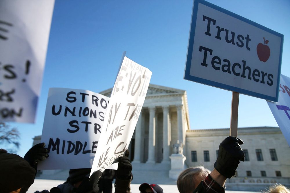 People for and against unions hold up signs in front of the U.S. Supreme Court building January 11, 2016 in Washington, D.C. (Mark Wilson/Getty Images)