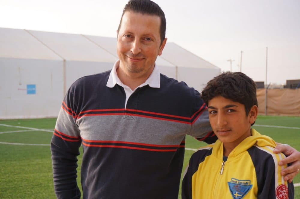 Raed Nimri (left), director of programs for Mercy Corps in Jordan poses for a picture with Hassan Ahmad at Zaatari refugee camp. (Dale Gavlak)