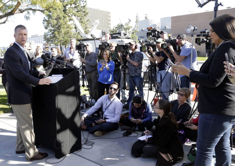 Orange County Sheriff's Department Public Information Officer Lt. Jeff Hallock, left, takes questions from the media in Santa Ana, Calif., on Monday, Jan. 25, 2016. Three inmates from Orange County Men's Central Jail, including a man suspected in a killing, cut through metal, crawled through plumbing tunnels, climbed a roof and rappelled down four stories to freedom using ropes made from bed-sheets. (AP Photo/Nick Ut)