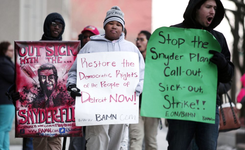 Demonstrators protest a hearing at the State of Michigan Building January 25, 2016 in Detroit, Michigan. The hearing will decide whether or not to order an end to the "sick-out" by Detroit Public School teachers and organizers. One sick-out last week led to the closing of 88 Detroit schools. (Bill Pugliano/Getty Images)
