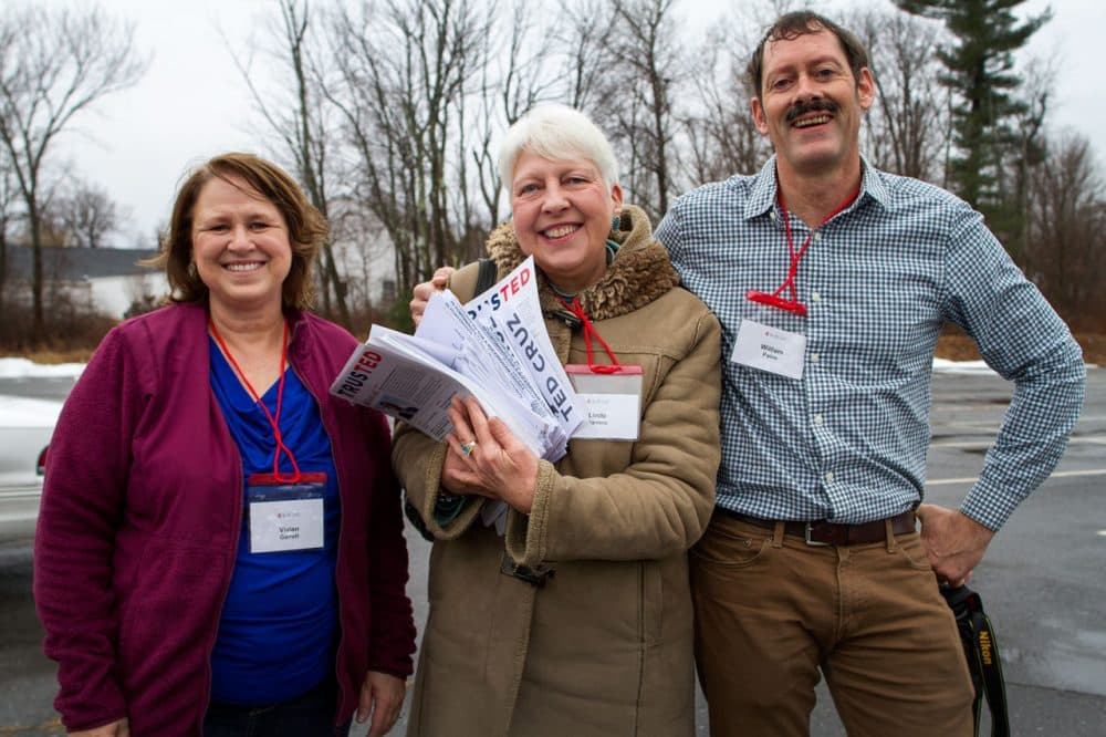 From left to right, Vivian Garrett, of Alabama, Linde Barrera, of New York, and William Paire, of West Virginia, stop in the parking lot outside of “Camp Cruz” before setting off for a day of canvassing. (Hadley Green for WBUR)