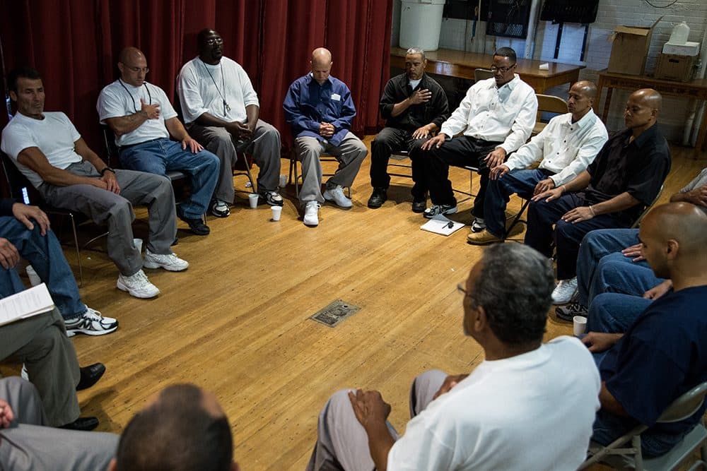 Inmates participate in a group meditation prior to a group discussion during the Restorative Justice Retreat at the Massachusetts Correctional Institution Norfolk in Norfolk, Massachusetts on June 22, 2014.