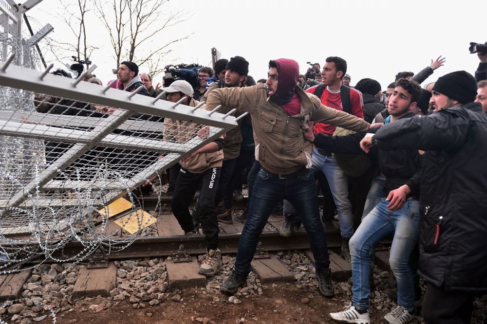 Refugees break into the Greek-Macedonian borders during their protest demanding the opening of the borders near the village of Idomeni on February 29, 2016.
Macedonian police fired tear gas on February 29, 2016, as a group of some 300 Iraqi and Syrians forced their way through a Greek police cordon and raced towards a railway track between the two countries. With Austria and Balkan states capping the numbers of migrants entering their soil, there has been a swift buildup along the Greece-Macedonia border with Athens warning that the number of people "trapped" could reach up to 70,000 by next month. (Louisa Gouliamaki/AFP/Getty Images)