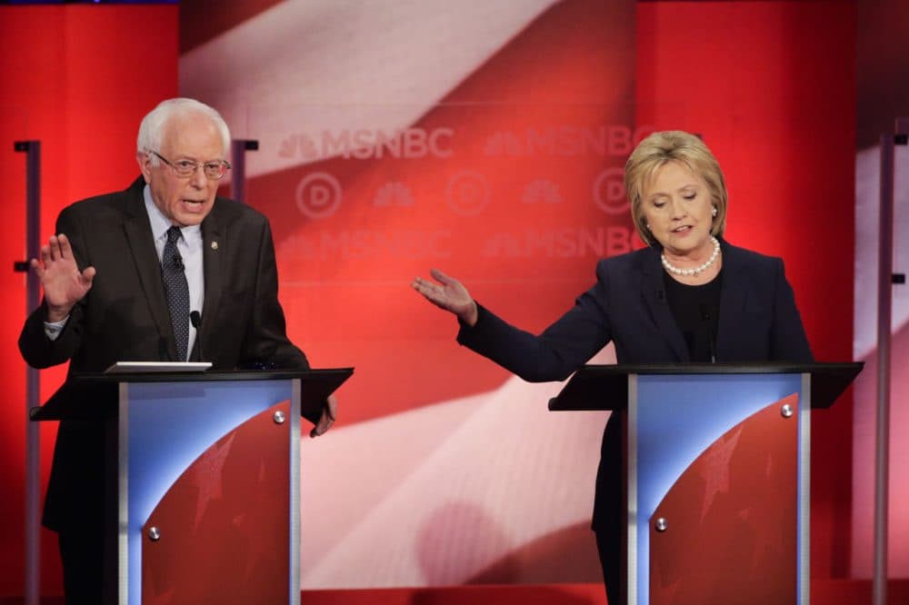 The last WBUR poll before the New Hampshire primary finds Bernie Sanders holding a 15-point lead over Hillary Clinton. Here, the two Democrats debate at the University of New Hampshire Thursday. (David Goldman/AP)