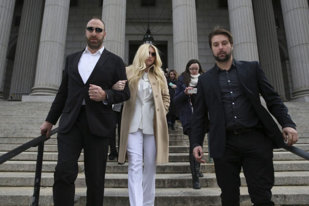Pop star Kesha, center, leaves Supreme court in New York, Friday, Feb. 19, 2016. Kesha is fighting to wrest her career away from a hitmaker she says drugged, sexually abused and psychologically tormented her _ and still has exclusive rights to make records with her. Producer Dr. Luke says the singer is slinging falsehoods and ruining his reputation to try to weasel out of her recording contract and strike a new deal. (AP Photo/Mary Altaffer)