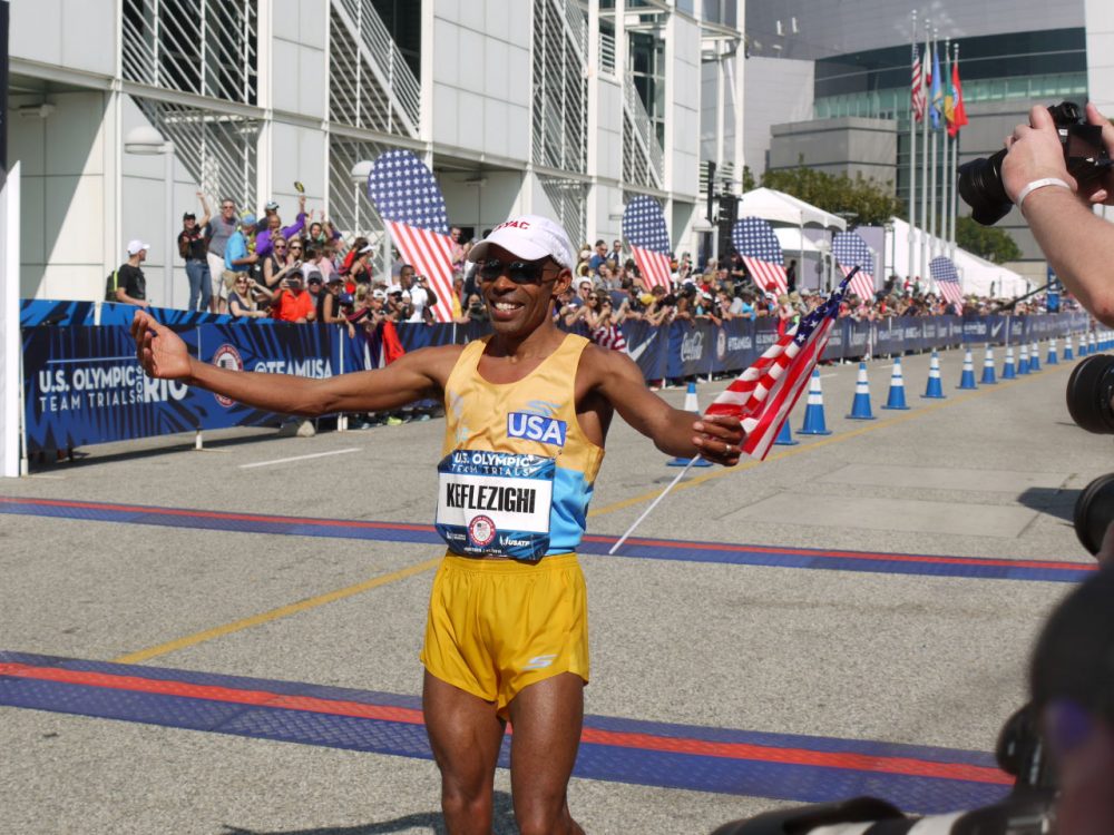Meb Keflezighi celebrates qualifying for the Olympics. He finished second in the Olympic Marathon Trials race in Los Angeles on February 13. (Alex Ashlock/Here & Now)