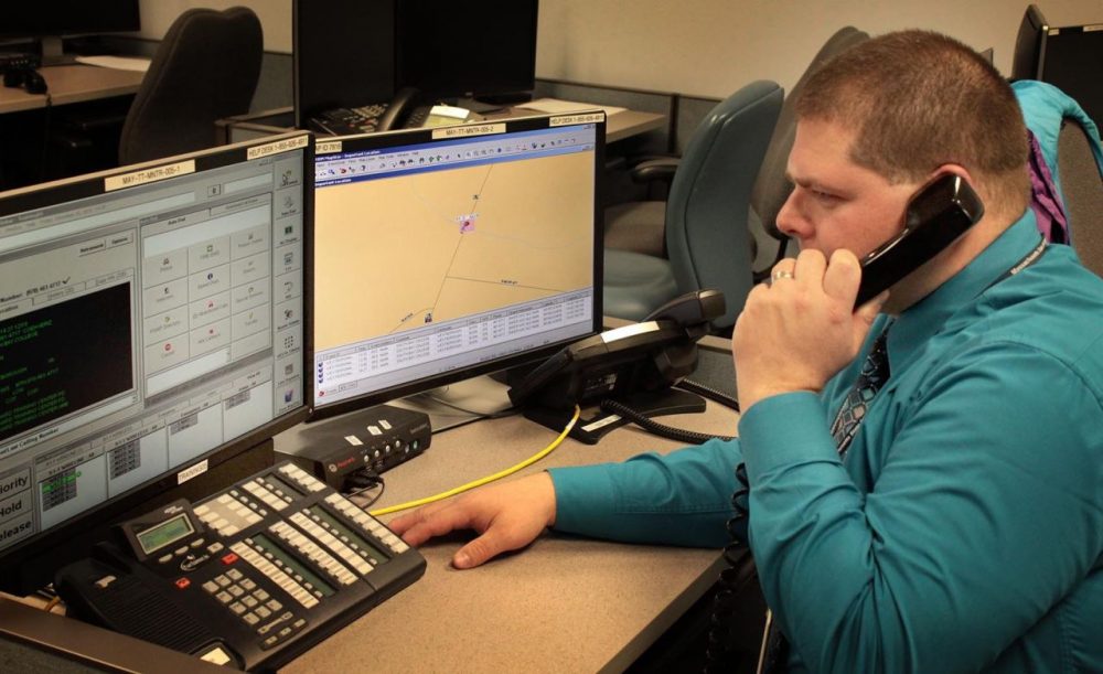 Training specialist Kevin Lewis of the Massachusetts 911 department at a call center training screen. (Carey Goldberg/WBUR)