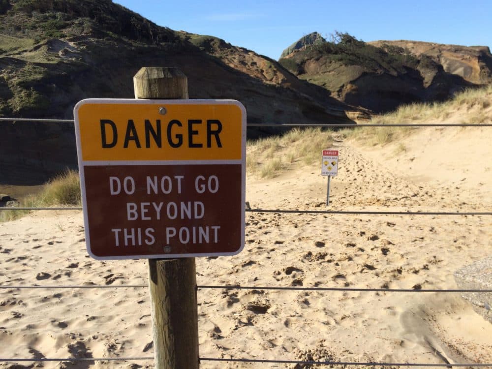 Footprints in the sand behind this fence show how frequently visitors ignore the warning signs at Cape Kiwanda.
CHRIS LEHMAN / NORTHWEST NEWS NETWORK