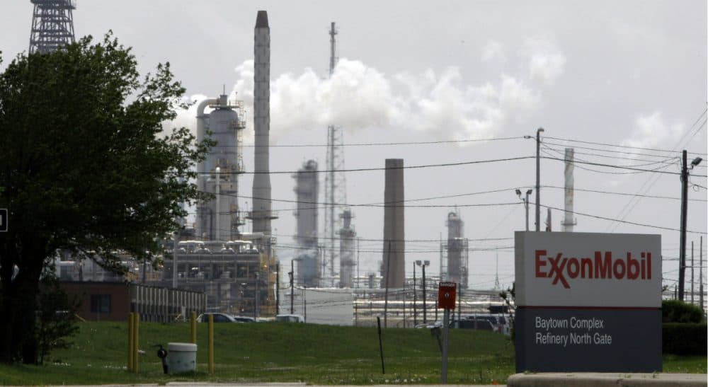 Did the oil giant lie to shareholders about business risks stemming from climate change? And how far did the corporation's efforts to sway scientific opinion go? In this 2010 photo, steam rises from towers at an Exxon Mobil refinery in Baytown, Texas. (Pat Sullivan/AP)