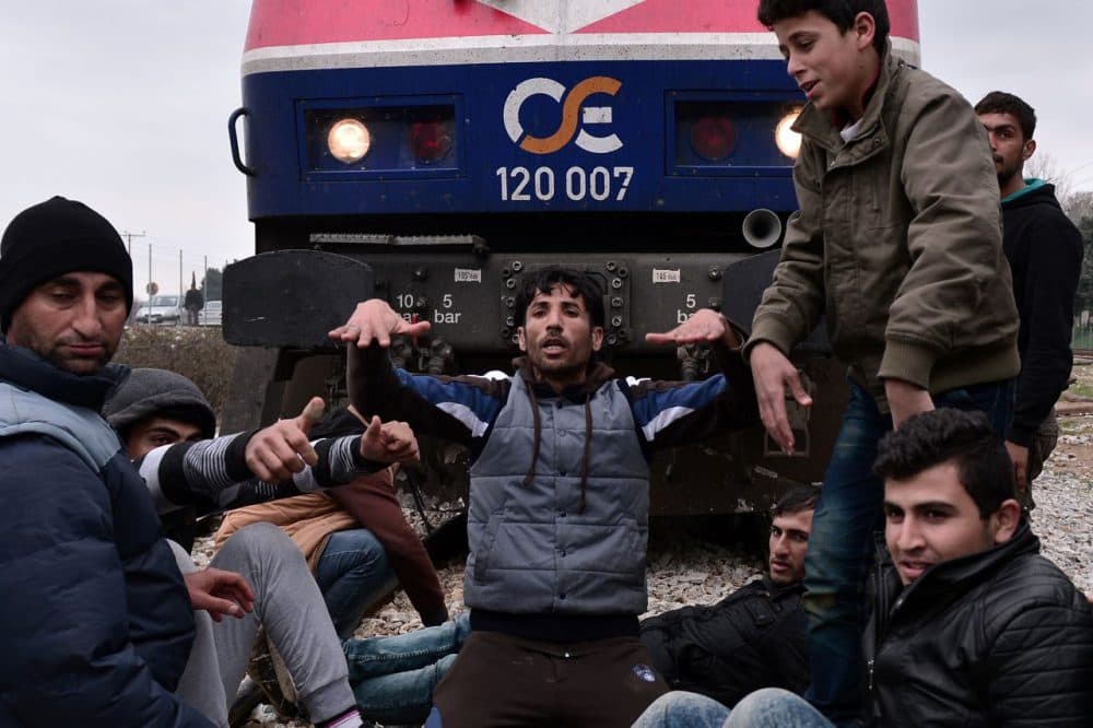 Syrian and Iraqi refugees trapped at the Greek-Macedonian borders stop an arriving train during their protest demanding the opening of the borders on February 28 , 2016.
A number of Balkan countries have closed their borders to migrants. (Louisa Gouliamaki/AFP/Getty Images)