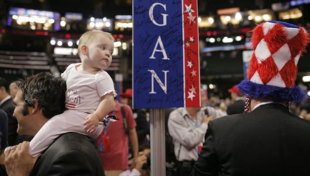 Nine-month-old Jetsen Minter looks at a passing delegate's hat as she sits on her father Derek Minter's shoulders at the Republican National Convention in St. Paul, Minn., Thursday, Sept. 4, 2008. Minter is a delegate from Holland, Michigan. (Jae C. Hong/AP)