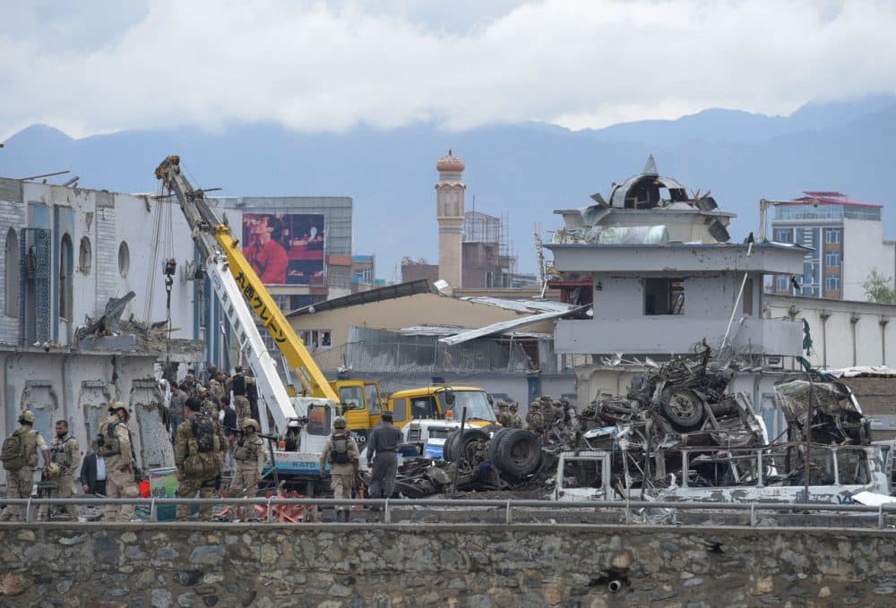 Afghan security personnel inspect the site of car bomb attack at the gate of a government office in the Puli Mahmood Khan neighbourhood of Kabul on April 19, 2016. A powerful Taliban car bomb followed by a fierce firefight left many people dead or wounded in Kabul April 19, the Afghan president said, a week after the insurgents launched their annual spring offensive.(Shah Marai/AFP/Getty Images)