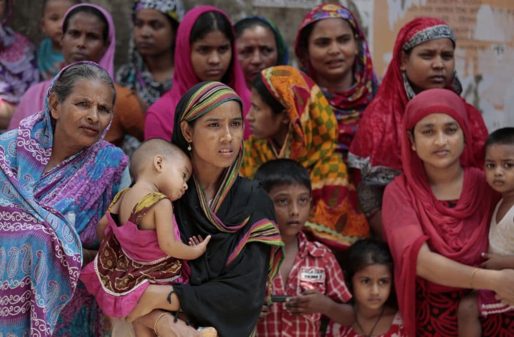 Locals gather outside a building where two people were killed by unidentified assailants in Dhaka, Bangladesh, Tuesday, April 26, 2016. Bangladeshi prime minister has vowed to hunt down and prosecute those who fatally stabbed two men, gay rights activist Xulhaz Mannan and his theater actor friend Tanay Majumder, and accused the country's opposition party and allied militants of orchestrating the attack. (AP Photo)
