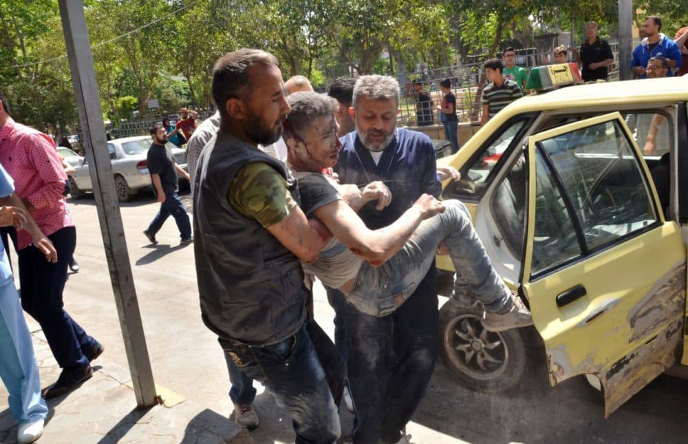 Syrian men carry an injured youth in the government-controlled side of the northern city of Aleppo following fighting between regime forces and rebels on April 28, 2016. The Syrian army was preparing an offensive to retake the whole of Aleppo, as fighting in the divided second city killed 38 civilians in a new blow for a tattered truce. Nearly 200 people have been killed in Aleppo in the past week as rebels have pounded government-held neighborhoods with rocket and artillery fire and the regime has hit rebel areas with air raids. U.N. envoy Staffan de Mistura warned the hard-won February 27 ceasefire was now "barely alive" and pleaded for urgent action by its cosponsors Russia and the United States to rescue it. But pro-government newspaper Al-Watan said the army was now poised for a "decisive battle" for Aleppo and the surrounding province which would begin in the coming days. (George Ourealian/AFP/Getty Images)