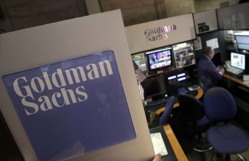 In this March 15, 2012 photo, a trader works in the Goldman Sachs booth on the floor of the New York Stock Exchange. Goldman Sachs reached a $5 billion settlement as part of a federal and state probe into its role in the sale of mortgages in the years leading up into the housing bubble and subsequent financial crisis. (Richard Drew/AP)