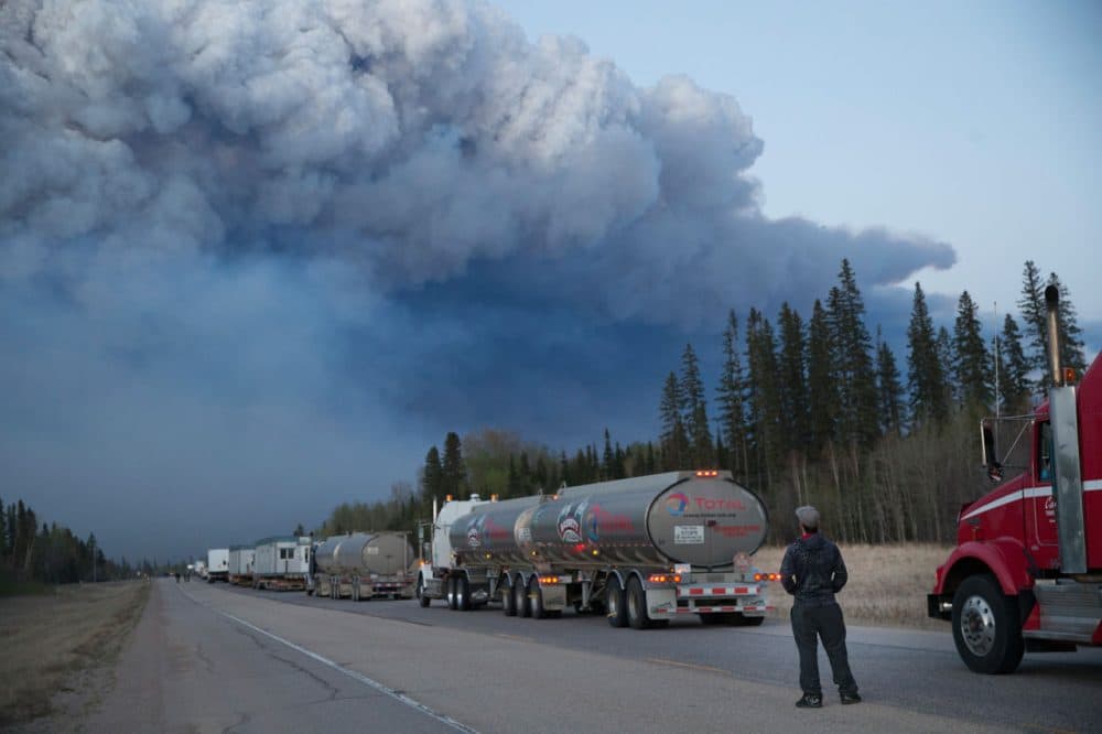 Drivers wait for clearance to take firefighting supplies into town on May 05, 2016 outside of Fort McMurray, Alberta. Wildfires, which are still burning out of control, have forced the evacuation of more than 80,000 residents from the town. (Scott Olson/Getty Images)