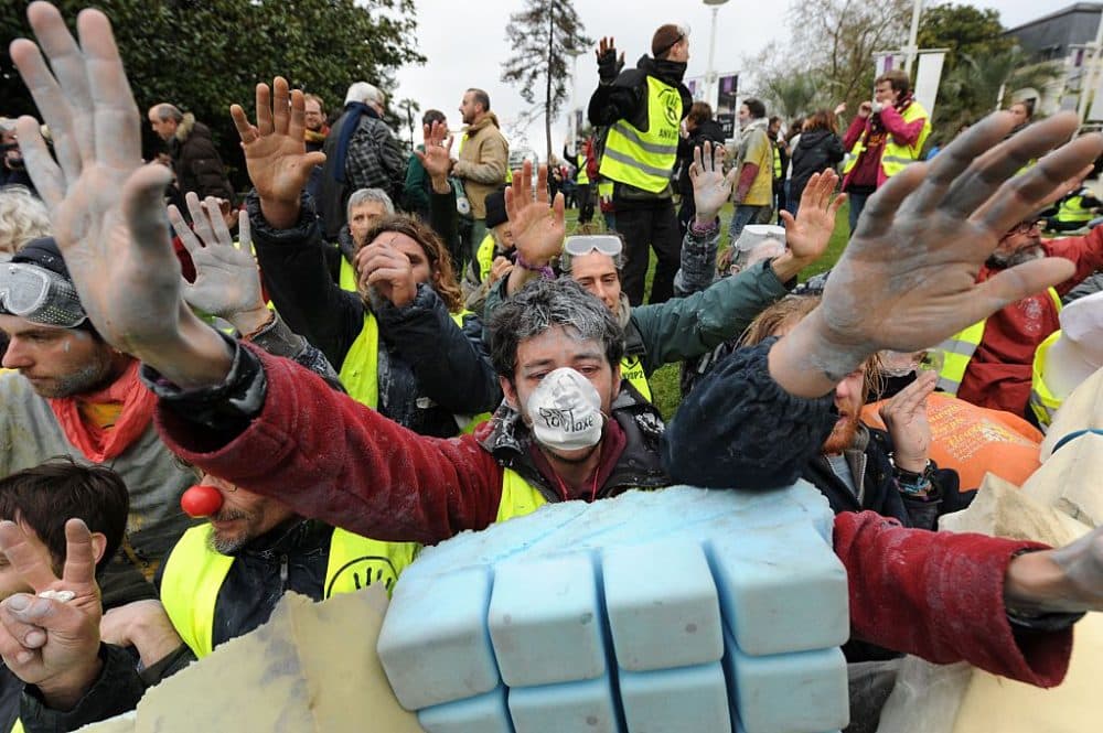 Environmental activists stage a protest against the MCE Deepwater Development 2016 event on offshore drilling, deepwater oil and gas markets, outside the Palais Beaumont in Pau, southwestern France, on April 5, 2016.
Several environmental groups, who mobilized during the COP21, called for the cancellation of the MCE event on the exploitation of offshore oil, that takes place in Pau through April 5-7, they see in "contradiction" with the commitments of the Paris Conference on Climate Change. (IROZ GAIZKA/AFP/Getty Images)