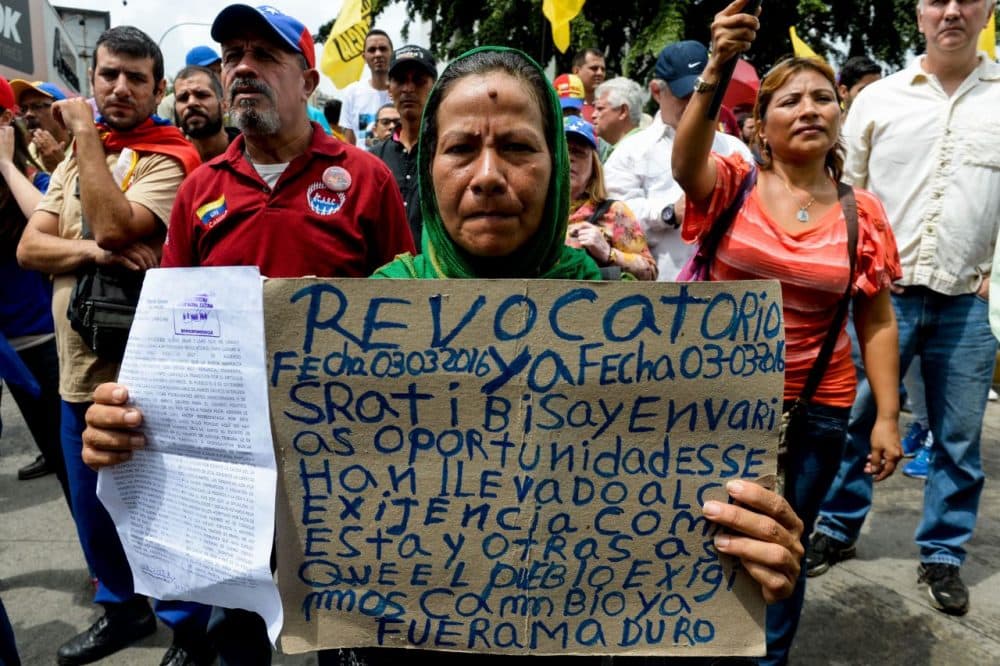 Opponents of the government of Venezuelan President Nicolas Maduro take part in a demonstration in Caracas on May 14, 2016. Venezuela braced for protests Saturday after Maduro declared a state of emergency to combat the "foreign aggression" he blamed for an economic crisis that has pushed the country to the brink of collapse. (Federico Parra/AFP/Getty Images)