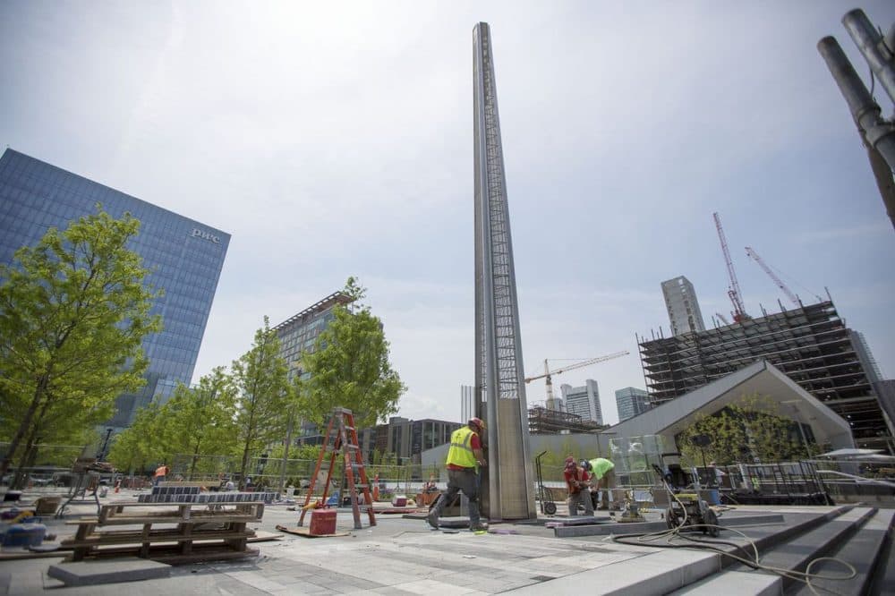 Workers put finishing touches on the Massachusetts Fallen Heroes Memorial in the Seaport on Thursday. (Jesse Costa/WBUR)