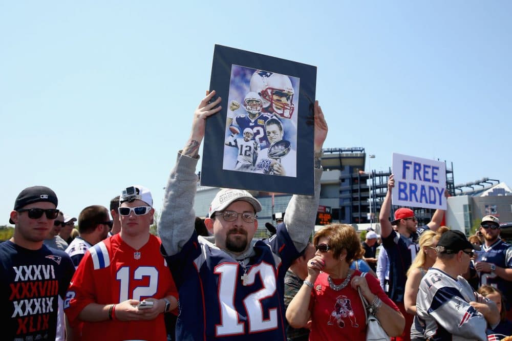 FOXBORO, MA - MAY 24: Paul Goodrow of Watertown, Massachusetts holds a sign in support of New England Patriots quarterback Tom Brady at the "Free Tom Brady" rally at Gillette Stadium on May 24, 2015 in Foxboro, Massachusetts. The rally was held in protest of Brady's four game suspension for his role in the "deflategate" scandal. (Photo by Maddie Meyer/Getty Images)