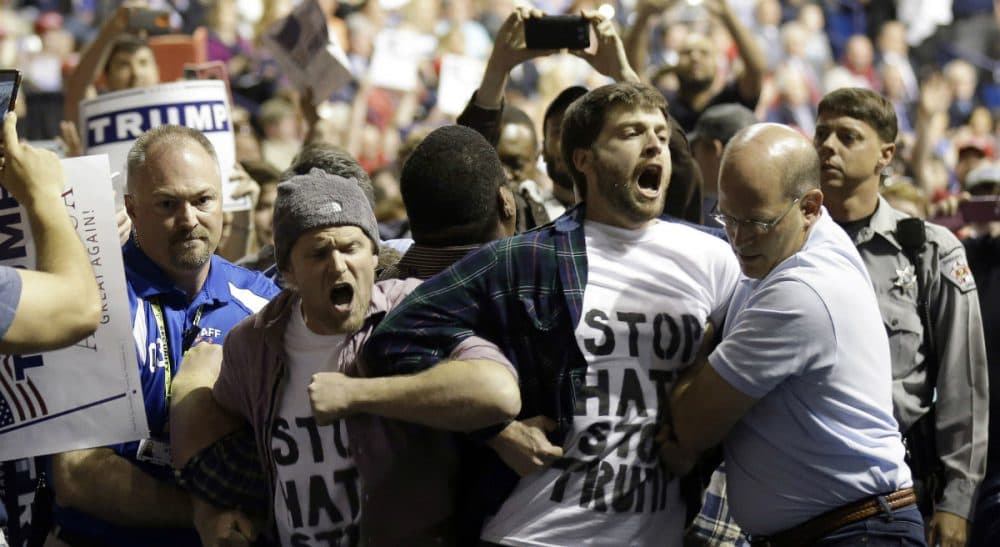 Joelle Renstrom: "Has Trump’s venom so poisoned the national dialogue that violence and vitriol have become standard currency?" Pictured: Protesters are removed as Republican presidential candidate Donald Trump speaks during a campaign rally in Fayetteville, N.C. in March, 2016. The scene was violent and chaotic. (Gerry Broome/AP)